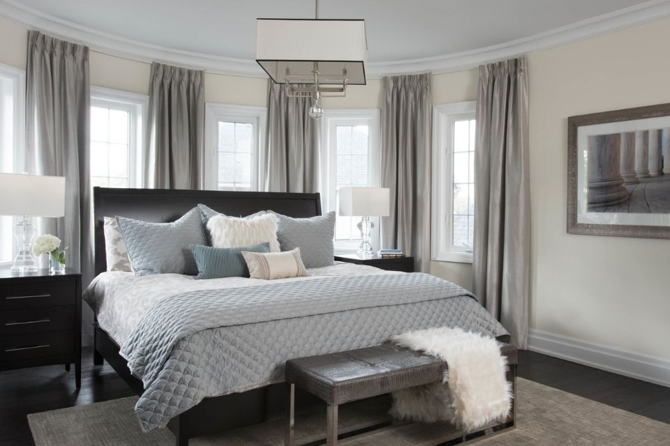 Bedroom with area rug beneath the bed but not under nightstands